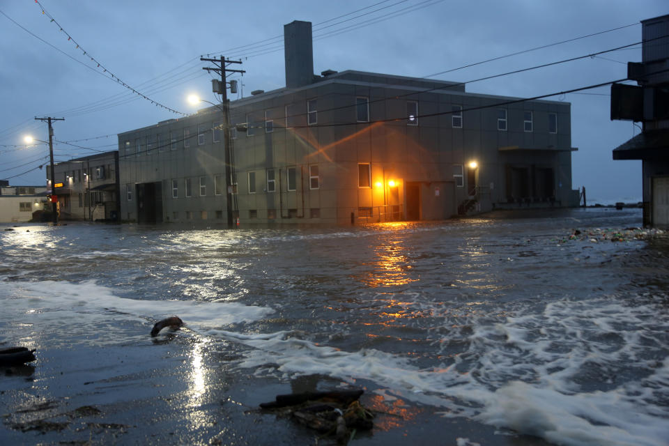 Water rushes down Front Street, just a half block from the Bering Sea, in Nome, Alaska, on Saturday, Sept. 17, 2022. Much of Alaska's western coast could see flooding and high winds as the remnants of Typhoon Merbok moved into the Bering Sea region. The National Weather Service says some locations could experience the worst coastal flooding in 50 years. (AP Photo/Peggy Fagerstrom)