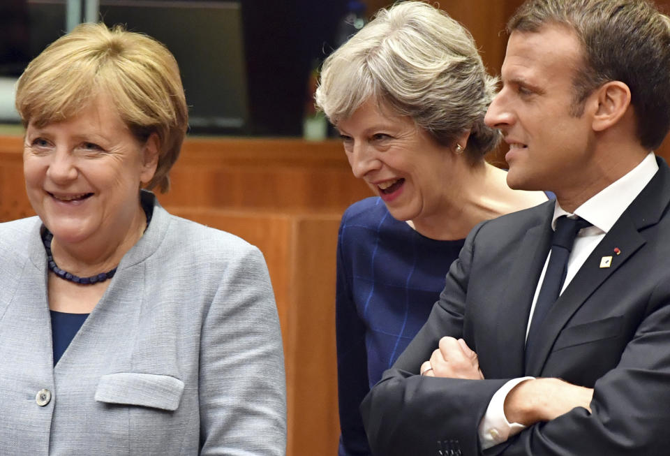 FILE - Then-British Prime Minister Theresa May, center, speaks with French President Emmanuel Macron, right, and German Chancellor Angela Merkel, left, during a round table meeting at an EU summit in Brussels on Thursday, Oct. 19, 2017. Former British Prime Minister Theresa May announced Friday, March 8, 2024, that she will quit as a lawmaker when an election is called this year, ending a 27-year parliamentary career that included three years as the nation’s leader during a period roiled by Brexit. (AP Photo/Geert Vanden Wijngaert, File)