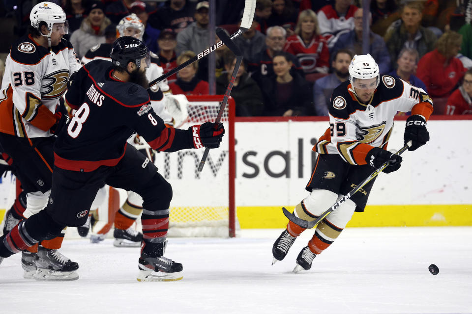 Carolina Hurricanes' Brent Burns (8) loses control of the puck to Anaheim Ducks' Sam Carrick (39) during the first period of an NHL hockey game in Raleigh, N.C., Saturday, Feb. 25, 2023. (AP Photo/Karl B DeBlaker)