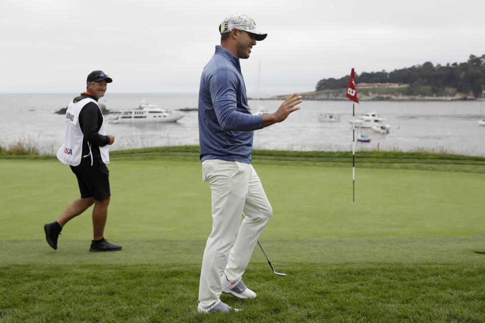 Brooks Koepka waves after his chip went in for birdie on the fifth hole during the first round of the U.S. Open Championship golf tournament Thursday, June 13, 2019, in Pebble Beach, Calif. (AP Photo/Marcio Jose Sanchez)