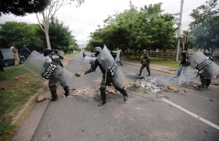 Members of the military police remove a barricade during a protest against the government of Honduras' President Juan Orlando Hernandez, in Tegucigalpa