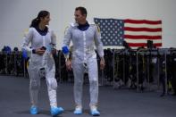 NASA commercial Crew astronauts Sunita Williams and Josh Cassada walk to get their awaiting space suits at NASA's Neutral Buoyancy Laboratory (NBL) training facility near the Johnson Space Center in Houston