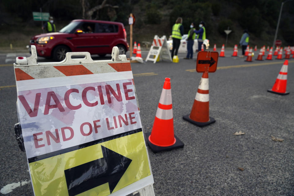 FILE - In this Jan. 30, 2021, file photo, drivers with a vaccine appointment enter a mega COVID-19 vaccination site set up in the parking lot of Dodger Stadium in Los Angeles, a day after it was temporarily shut down while protesters blocked the entrance. (AP Photo/Damian Dovarganes, File)