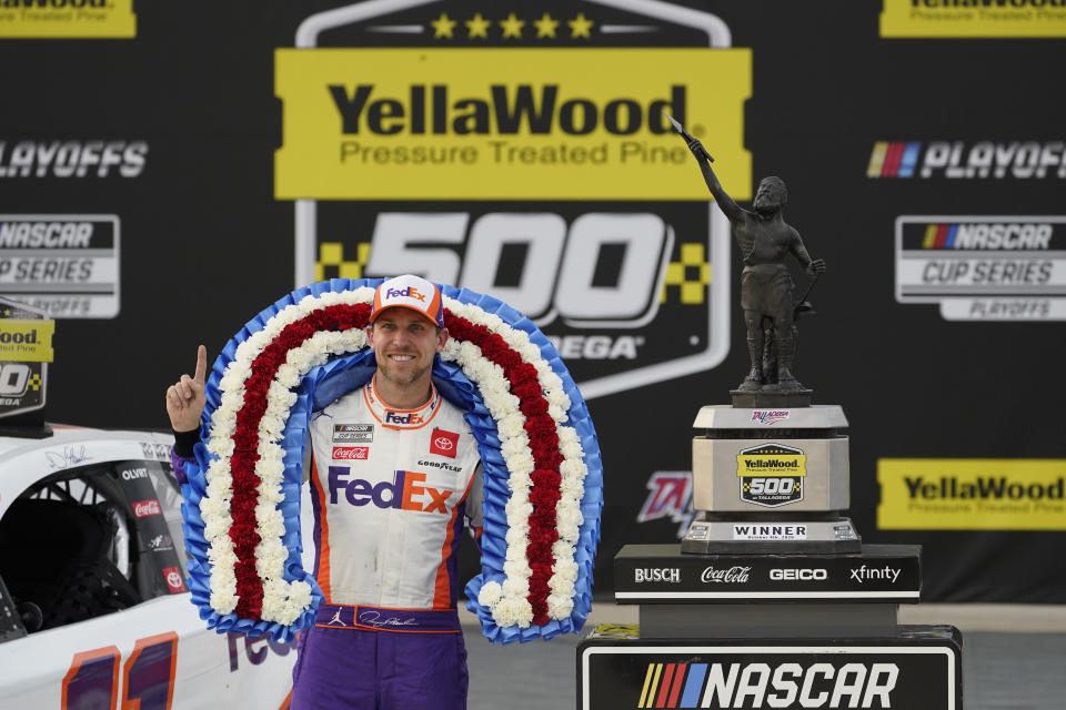 Denny Hamlin poses with the trophy after winning the NASCAR Cup Series auto race at Talladega Superspeedway on Sunday, Oct. 4, 2020, in Talladega, Ala. (AP Photo/John Bazemore)