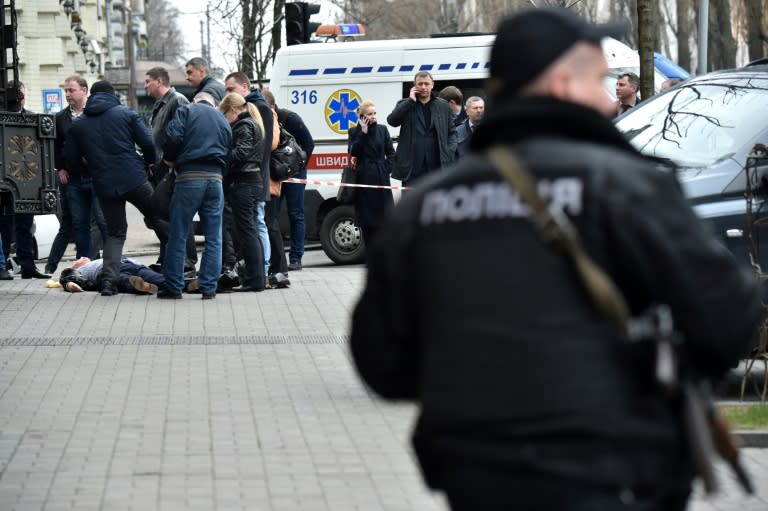 Ukrainian police inspect the body of Denis Voronenkov after the former Russian lawmaker was shot dead in Kiev, on March 23, 2017