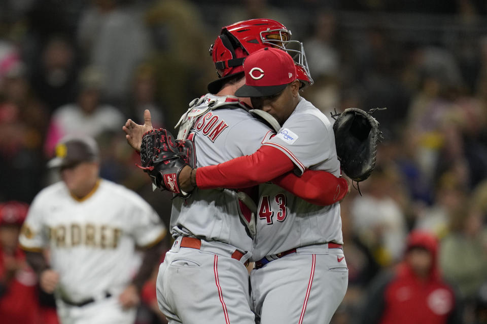 Cincinnati Reds relief pitcher Alexis Diaz, right, hugs catcher Tyler Stephenson after the Reds defeated the San Diego Padres 2-1 in a baseball game Tuesday, May 2, 2023, in San Diego. (AP Photo/Gregory Bull)