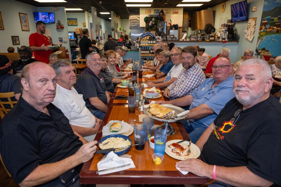 A large group from WQBQ fills the tables at Luigi's Italian Restaurant in Eustis on a day in April 2024.