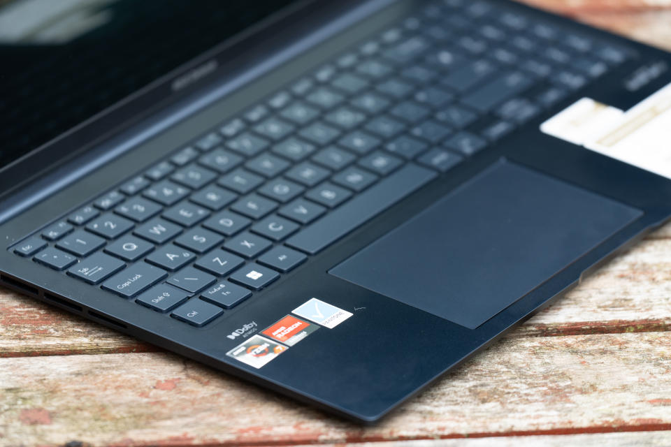 A black ASUS Zenbook 15 OLED laptop sitting on a table