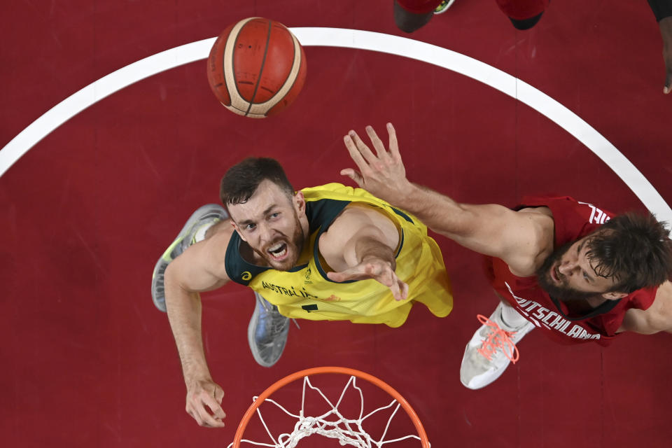 Australia's Nic Kay, left, shoots over Germany's Danilo Barthel during a men's basketball preliminary round game at the 2020 Summer Olympics, Saturday, July 31, 2021, in Saitama, Japan. (Aris Messinis/Pool Photo via AP)