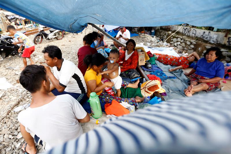 Displaced people because of the floods hide at a temporary shelter in Jakarta