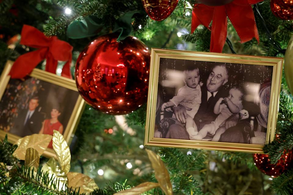 Photos of the Kennedys and Franklin Roosevelt on a White House Christmas tree in the State Dining Room.