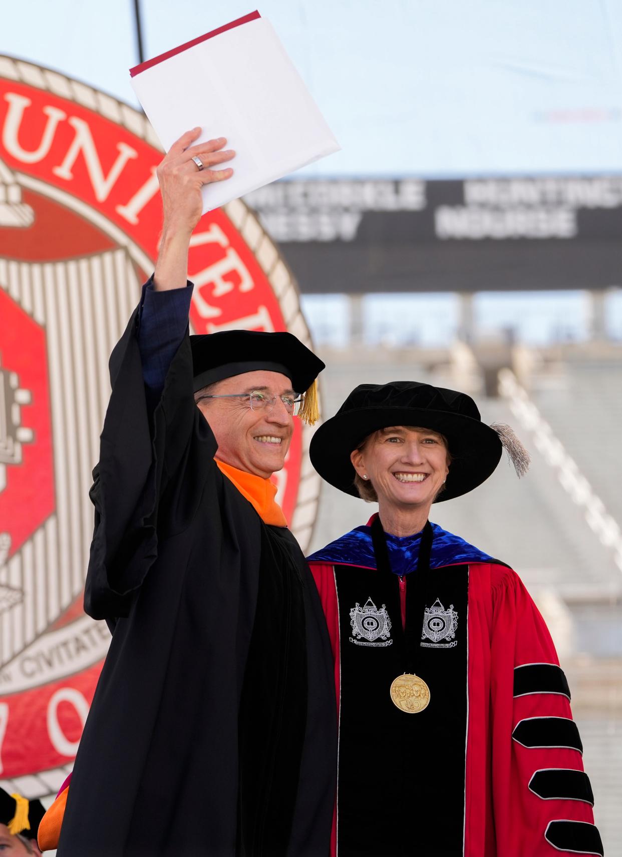 Patrick P. Gelsinger, left, CEO of Intel Corporation, celebrates after receiving an honorary doctorate of engineering from Ohio State University President Kristina M. Johnson, right, during spring commencement on May 8.