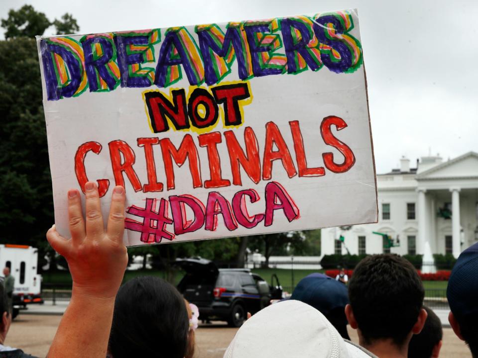 Demonstrators protest the Trump administration's decision to repeal DACA.