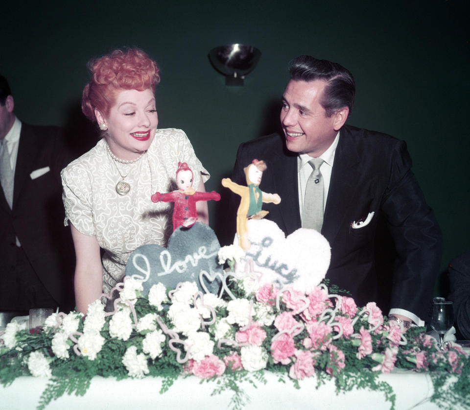 Lucille Ball and Desi Arnaz sit together while taking a break from filming "I Love Lucy"