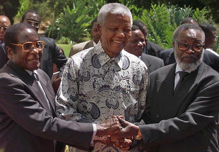 The three presidents of South Africa, Nelson Mandela, Zimbabwe's Robert Mugabe and Namibia's Sam Nujoma in Pretoria, 05 March 1999. Mugabe criticises Nelson Mandela for being too soft on whites, in a documentary giving a rare and intimate look into the family life of one of Africa's longest serving and most vilified leaders