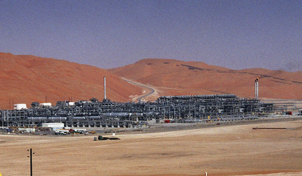 FILE - In this Monday, March 8, 2004 file photo, an industrial plant strips natural gas from freshly pumped crude oil is seen at Saudi Aramco's Shaybah oil field at Shaybah in Saudi Arabia's Rub al-Khali desert. Saudi state TV reported Saturday, Aug. 17, 2019, that a fire had been controlled at the massive oil and gas Shaybah field after a drone attack claimed by Yemen's Houthi rebels. (AP Photo/Bruce Stanley, File)