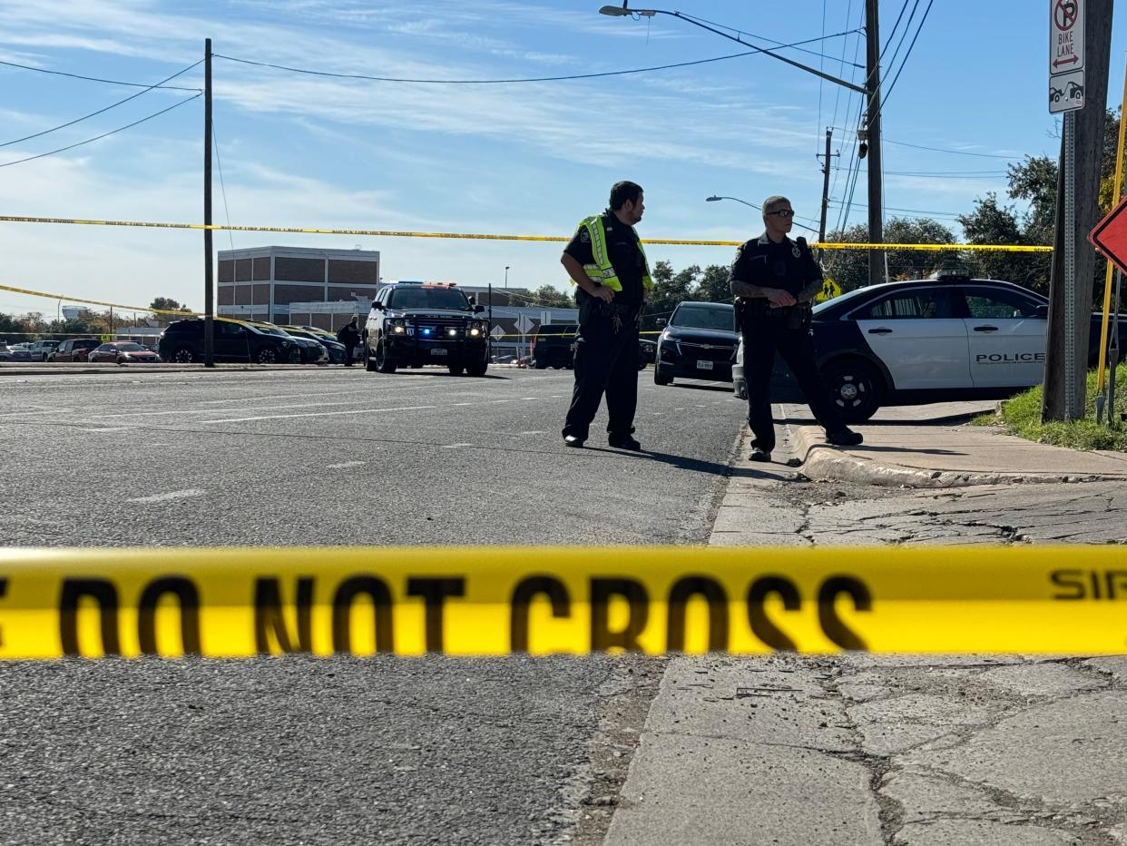 Streets near Northeast Early College High School are blocked off Tuesday, Dec. 5, 2023, after an AISD police officer was injured in a shooting.