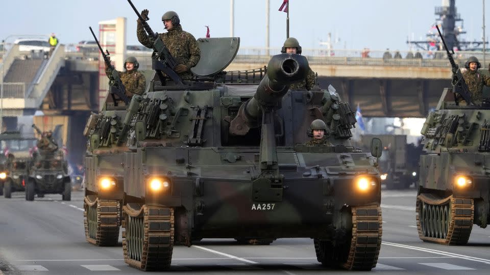 Latvian army servicemen with a M109A5 howitzer attend a military parade to celebrate the anniversary of the independence declaration in Riga, Latvia on November 18, 2022. - Ints Kalnins/Reuters