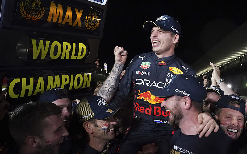Red Bull driver Max Verstappen celebrates with teammates