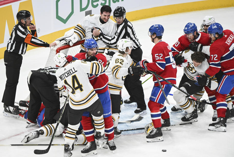 Boston Bruins and Montreal Canadiens players fight during third-period NHL hockey game action in Montreal, Saturday, Nov. 11, 2023. (Graham Hughes/The Canadian Press via AP)