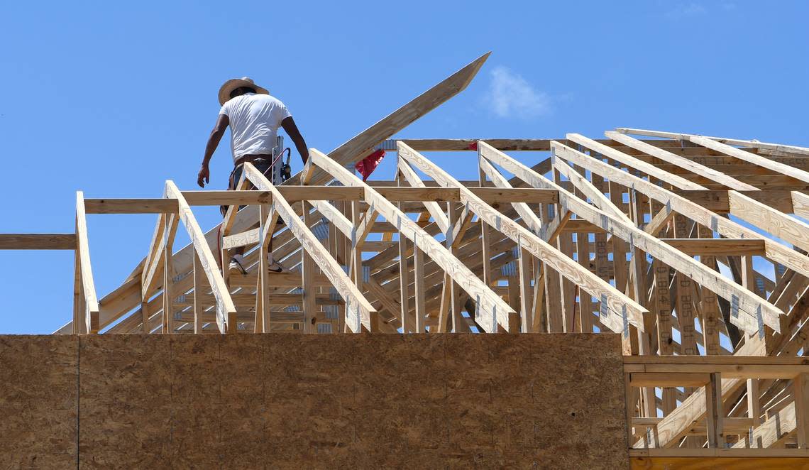 A contractor balances on the trusses of a roof in the second phase of Cypress Ridge of a home being built along Lou Baris Mill Lane on Thursday in Bluffton. In 2017, Cypress Ridge was one of the fastest growing neighborhoods in the greater Bluffton area.