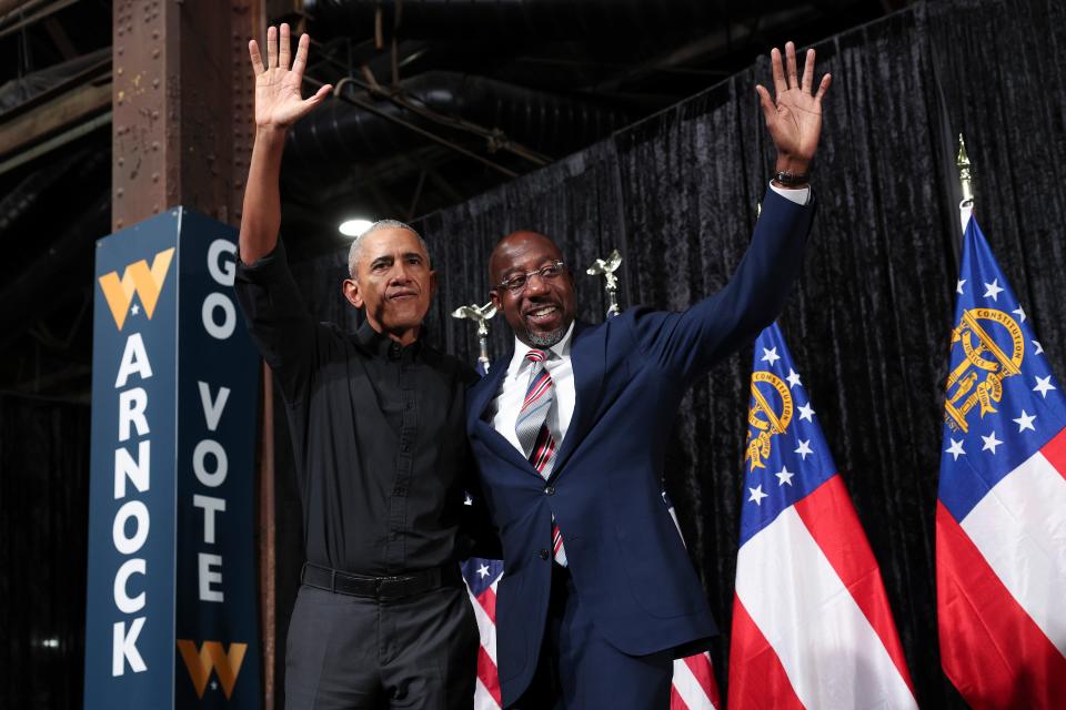 Former president Barack Obama campaigns with Georgia Democratic Senate candidate Raphael Warnock at a rally 1 December 2022 in Atlanta, Georgia (Getty Images)