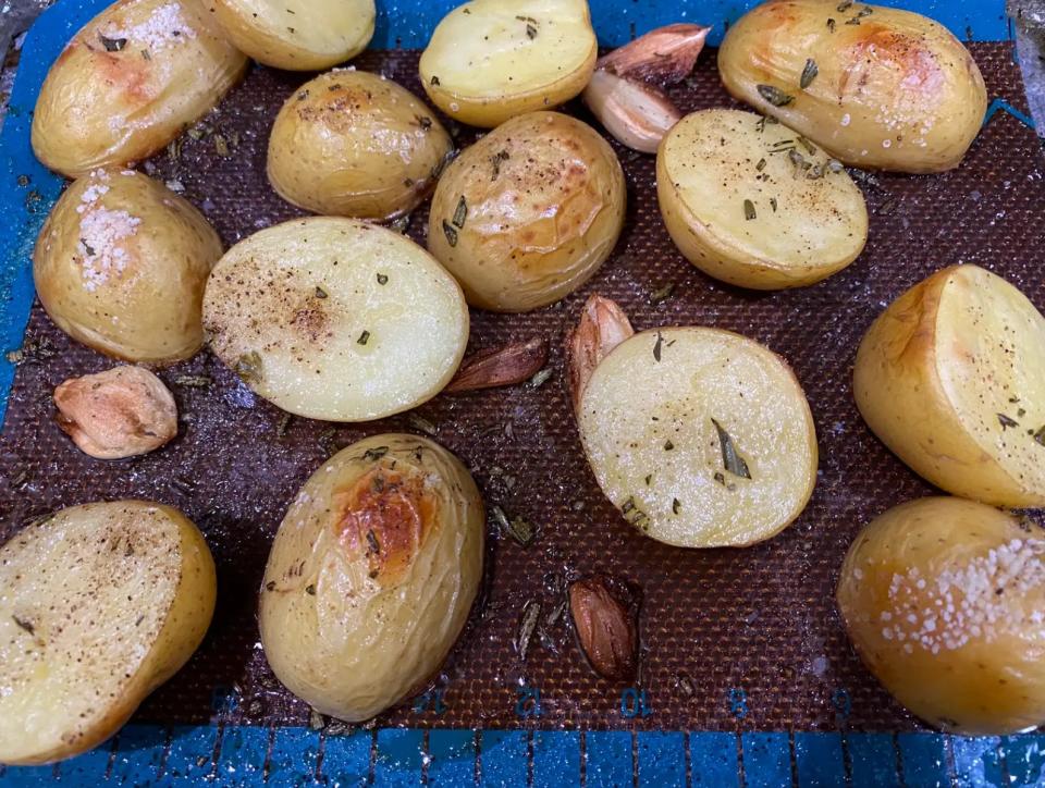 crispy roasted potatoes on a sheet pan with garlic and rosemary