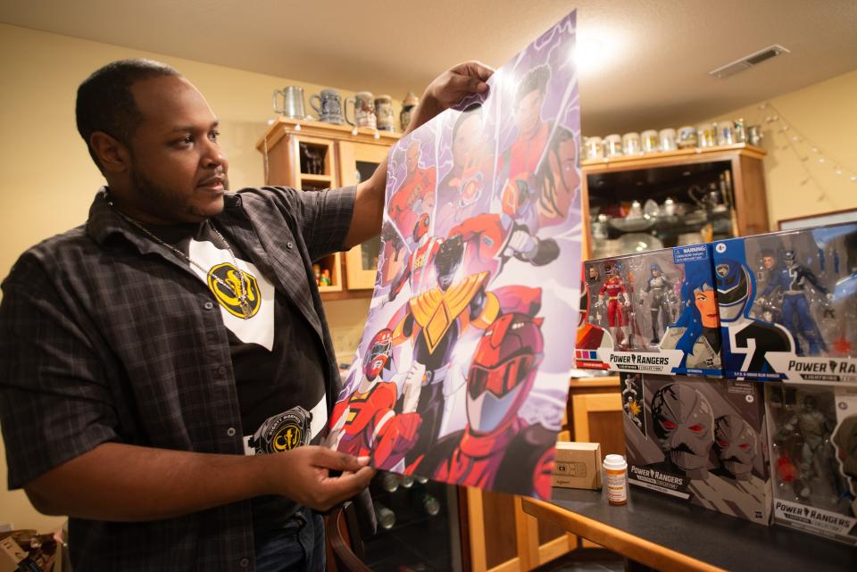 Dane Shobe shows off a poster he designed that grabbed the attention of the original Black Power Ranger, Walter Emmanuel Jones, in 2021.