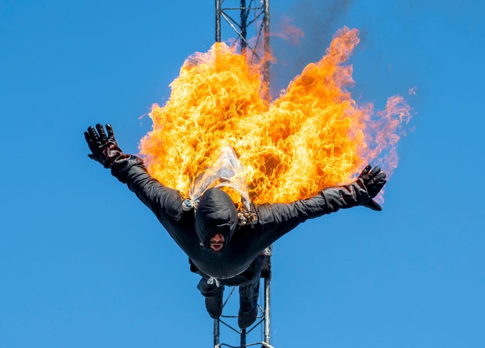 Johnny Gutierrez of San Antonio, Texas dives from a 33 ft ledge into a pool of water while on fire as part of a diving show put on by Watershow Productions Inc. at the Michigan State Fair in Novi at the Suburban Collection Showcase on September 1, 2022.