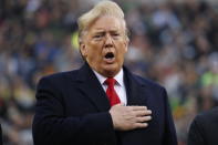 President Donald Trump holds his hand over his heart for the Pledge of Allegiance before the start of the Army-Navy college football game in Philadelphia, Saturday, Dec. 14, 2019. (AP Photo/Jacquelyn Martin)