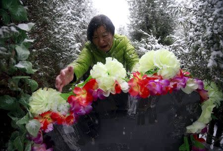 Zheng Qing cries as she shows reporters her son's resting place during their visit to the graveyard in Zhangjiakou, China, November 22, 2015. REUTERS/Kim Kyung-Hoon