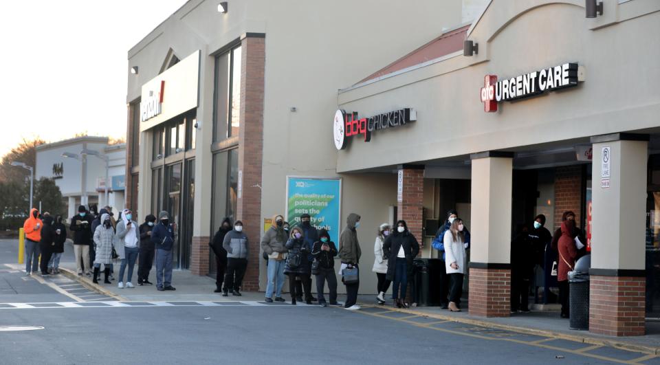 People stand in line to receive Covid-19 tests at AFC Urgent Care in Hartsdale, N.Y. on Dec. 20, 2021.