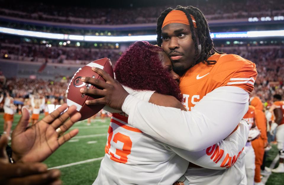 Texas' T'Vondre Sweat is used to bear-hugging anyone in his path, friend, foe or family.