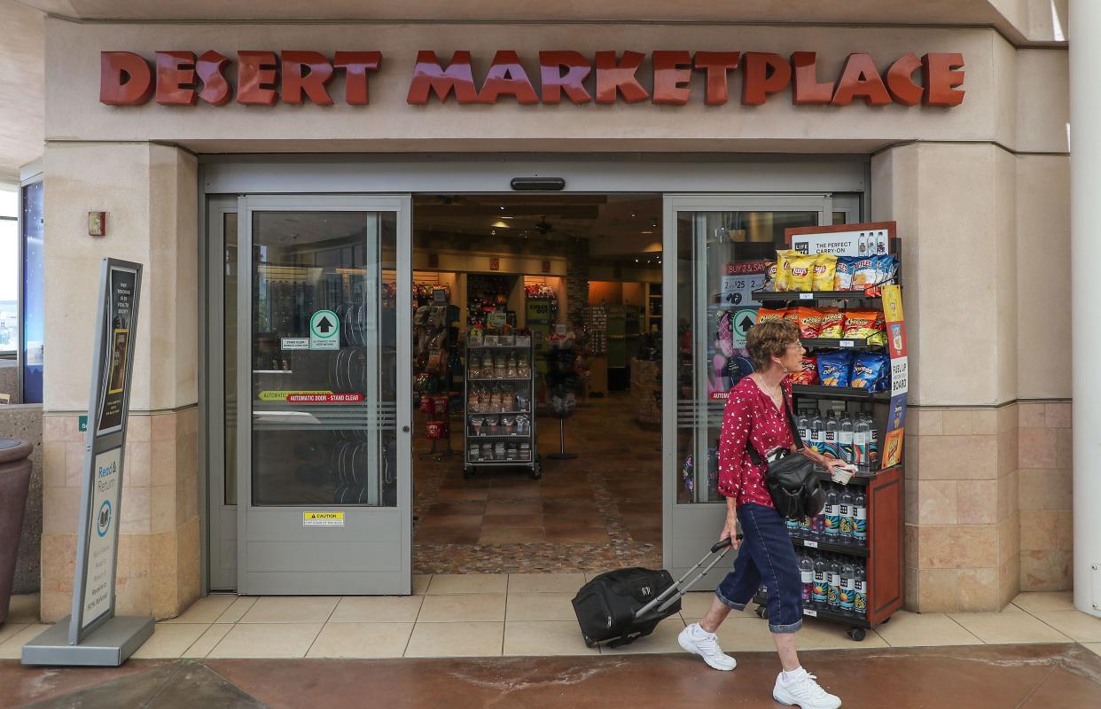 A traveler exits the Desert Marketplace shop in the Sonny Bono Concourse at the Palm Springs International Airport in June. The city council will consider a plan this week to replace most of the airport's existing shops and restaurants, including Desert Marketplace, with new offerings.