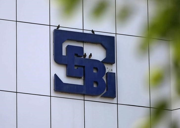 Birds rest on the logo of the Securities and Exchange Board of India (SEBI), India's market regulator, installed on the facade of its head office building in Mumbai, July 13, 2015. REUTERS/Shailesh Andrade/Files