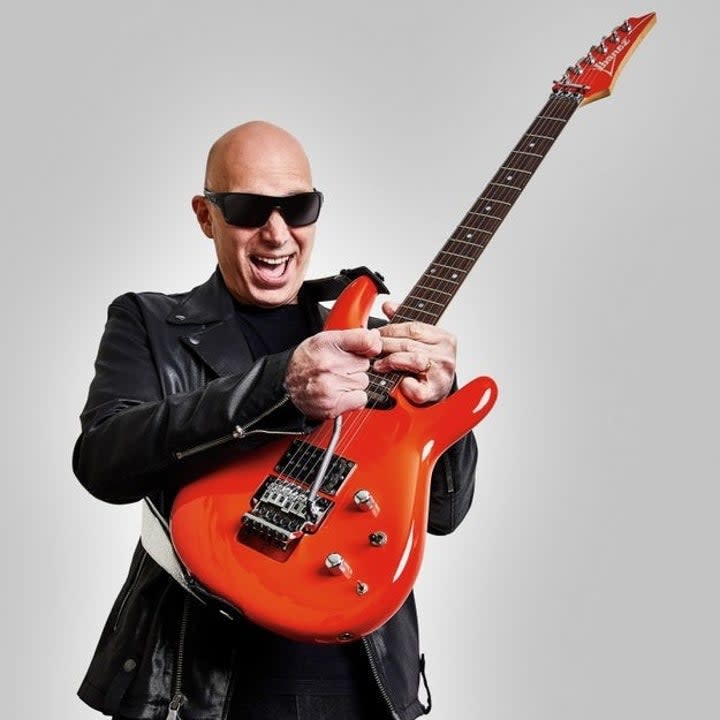 Joe Satriani playing the guitar on the cover of Guitar World Magazine