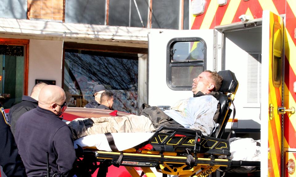 Sean Chesser is loaded into an ambulance following his arrest on Tuesday morning.