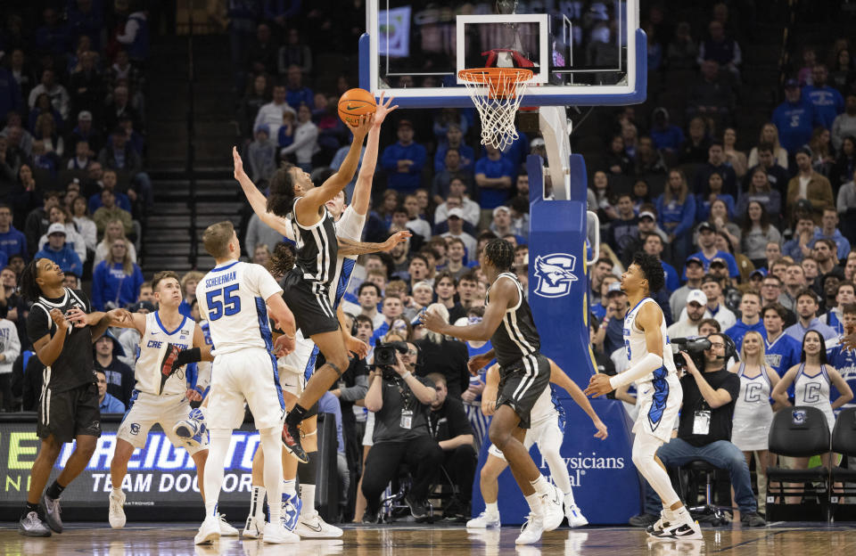 Creighton's Ryan Kalkbrenner, center, reaches to block a shot from Providence's Devin Carter, center left, during the second half of an NCAA college basketball game Saturday, Jan. 6, 2024, in Omaha, Neb. Creighton defeated Providence 69-60. (AP Photo/Rebecca S. Gratz)