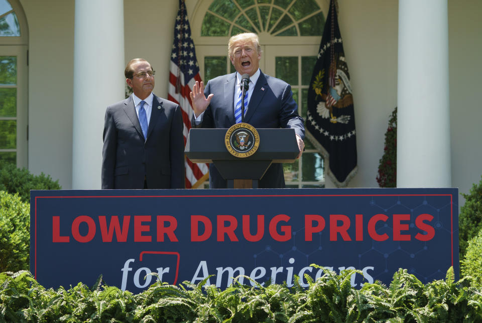 Trump, right, speaks at an event about lowering prescription drug prices. His patent office chief's speech at a fundraiser backed by Big Pharma raises questions about his commitment. (Photo: ASSOCIATED PRESS/Carolyn Kaster)