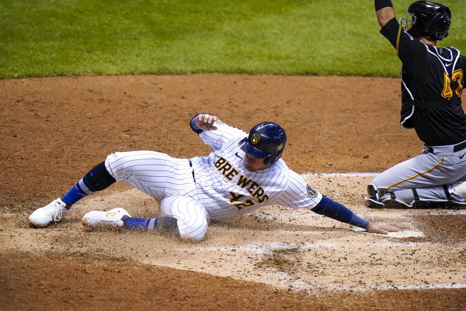 Milwaukee Brewers' Avisail Garcia slides safely home past Pittsburgh Pirates catcher Jacob Stallings during the fifth inning of a baseball game Friday, Aug. 28, 2020, in Milwaukee. Garcia scored from first on a double by Mark Mathias. (AP Photo/Morry Gash)