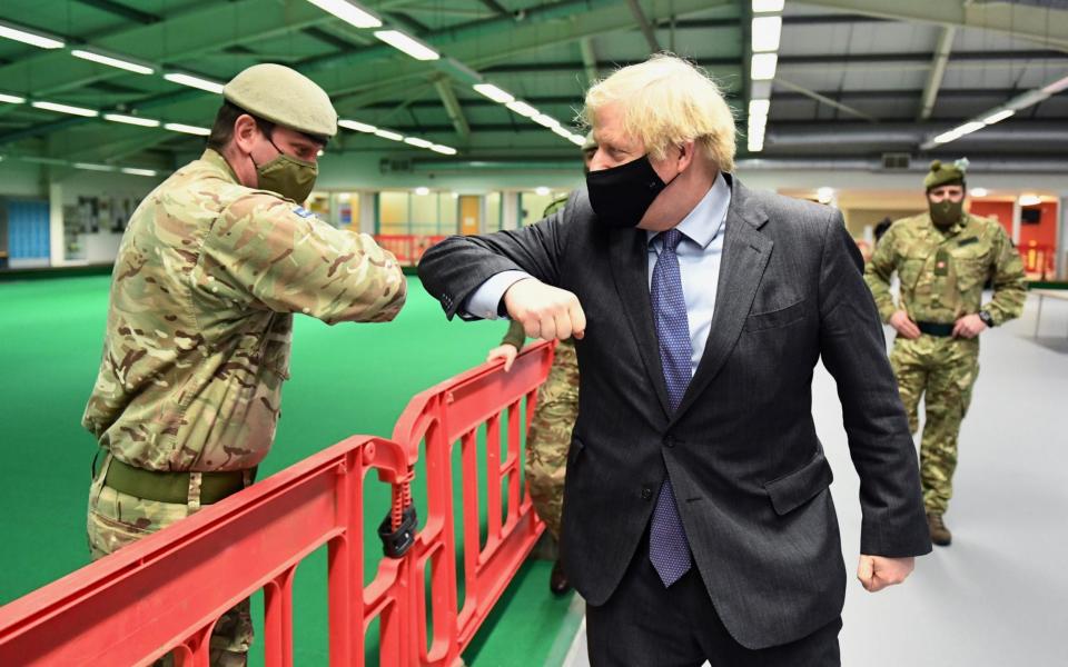 British Prime Minister Boris Johnson meets troops as they set up a vaccination centre in the Castlemilk district of Glasgow, Scotland, - Reuters