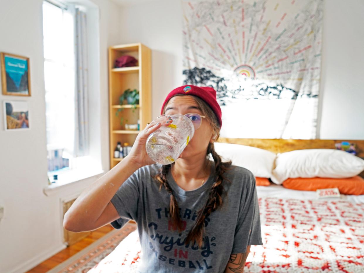 The author drinks a glass of water in her room