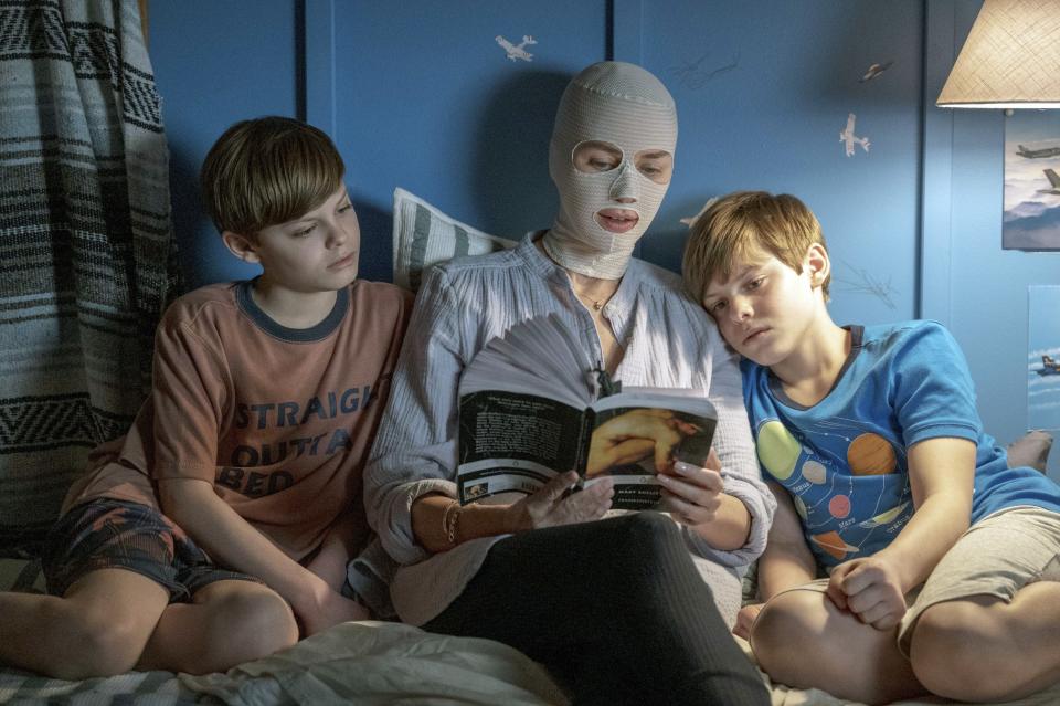 Naomi Watts' character reading a story to her twin boys