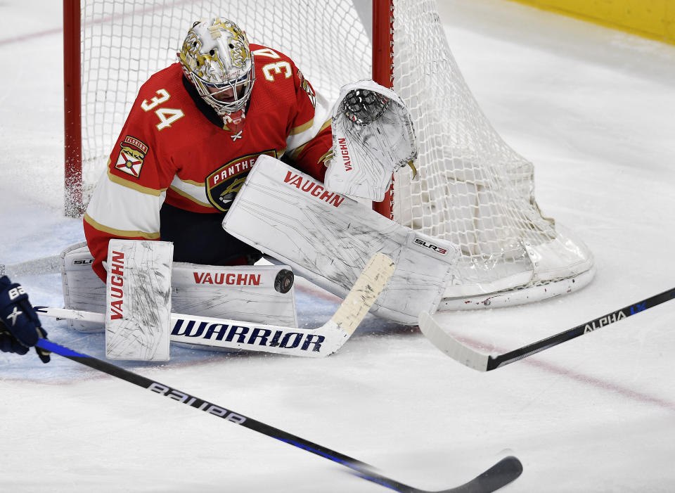 Florida Panthers goaltender Alex Lyon (34) stops the puck during the third period of an NHL hockey game against the Buffalo Sabres, Tuesday, April 4, 2023, in Sunrise, Fla. (AP Photo/Michael Laughlin)