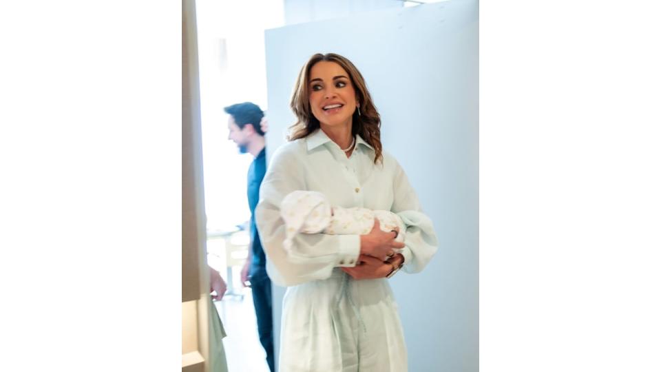 Queen Rania holding a baby girl