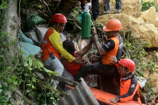 Days of heavy monsoon rains caused a steep slope of limestone and soil to collapse into at least 10 homes in Tina-an