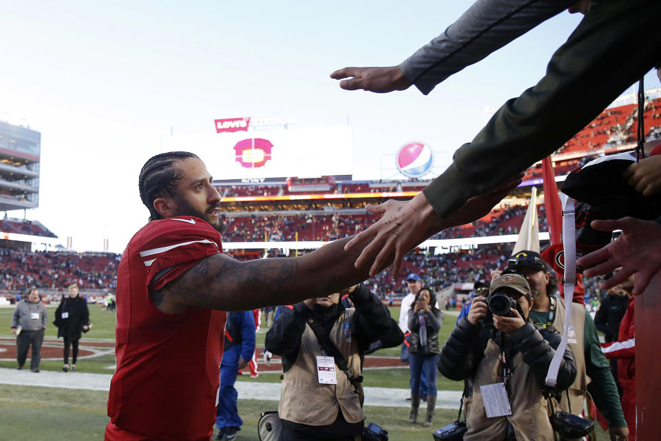 FILE - In this Jan. 1, 2017, file photo, San Francisco 49ers quarterback Colin Kaepernick greets fans after an NFL football game against the Seattle Seahawks in Santa Clara, Calif. It was his last game in the NFL.. (AP Photo/Tony Avelar, File)