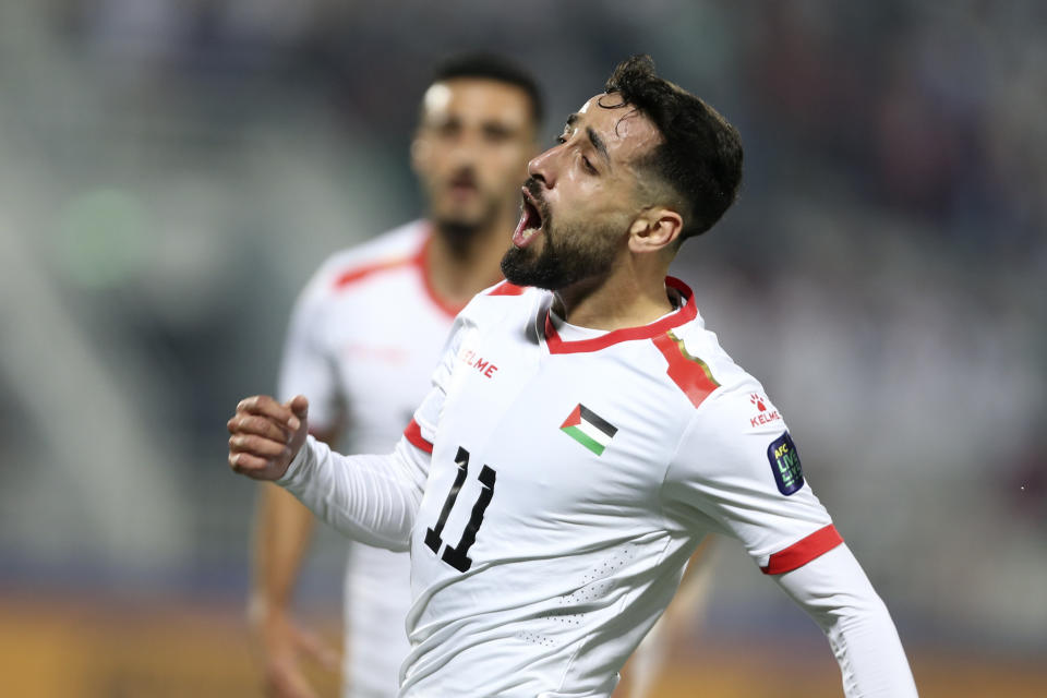 Palestine's Oday Dabbagh celebrates after scoring against Hong Kong during the Asian Cup Group C soccer match between Hong Kong and Palestine at Abdullah Bin Khalifa Stadium in Doha, Qatar, Tuesday, Jan. 23, 2024. (AP Photo/Hussein Sayed)