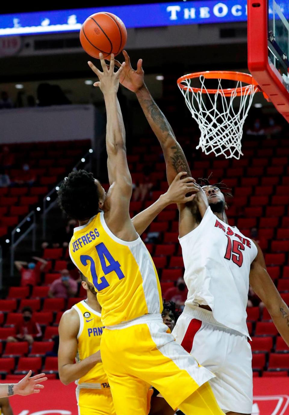 N.C. State’s Manny Bates (15) blocks the shot by Pittsburgh’s William Jeffress (24) during the first half of N.C. State’s game against Pittsburgh at PNC Arena in Raleigh, N.C., Sunday, February 28, 2021.