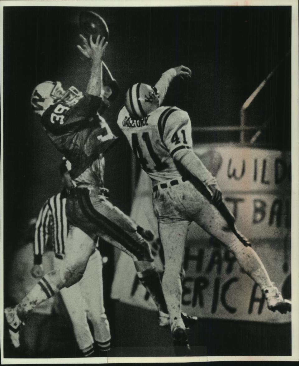 Wisconsin free safety Matt Vanden Boom snares an interception over a Kansas State receiver in the 1982 Independence Bowl.